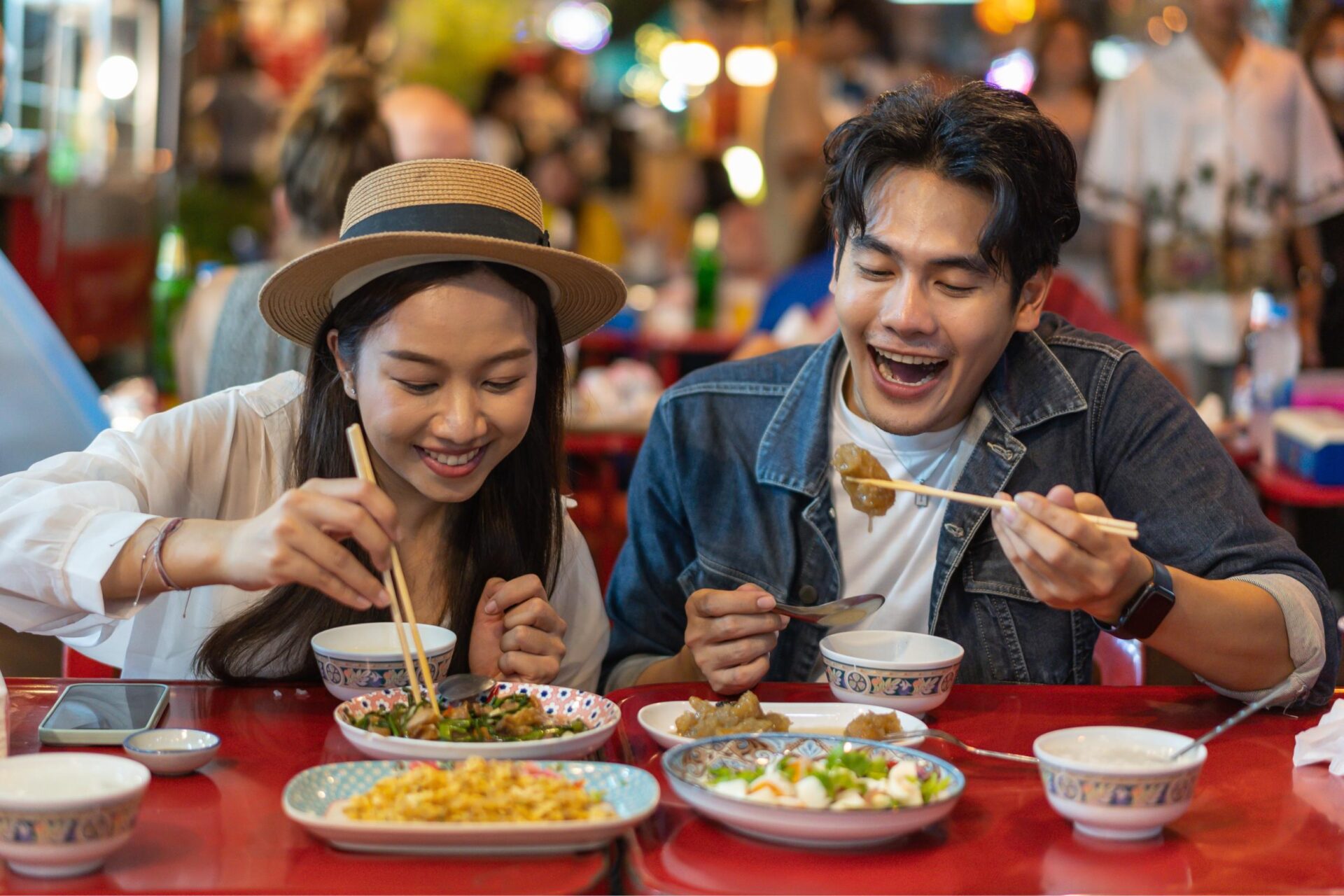 A couple enjoys sampling Bangkok Street food
