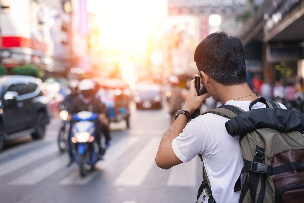 A photographer capturing street photography shots in Bangkokâs Chinatown.